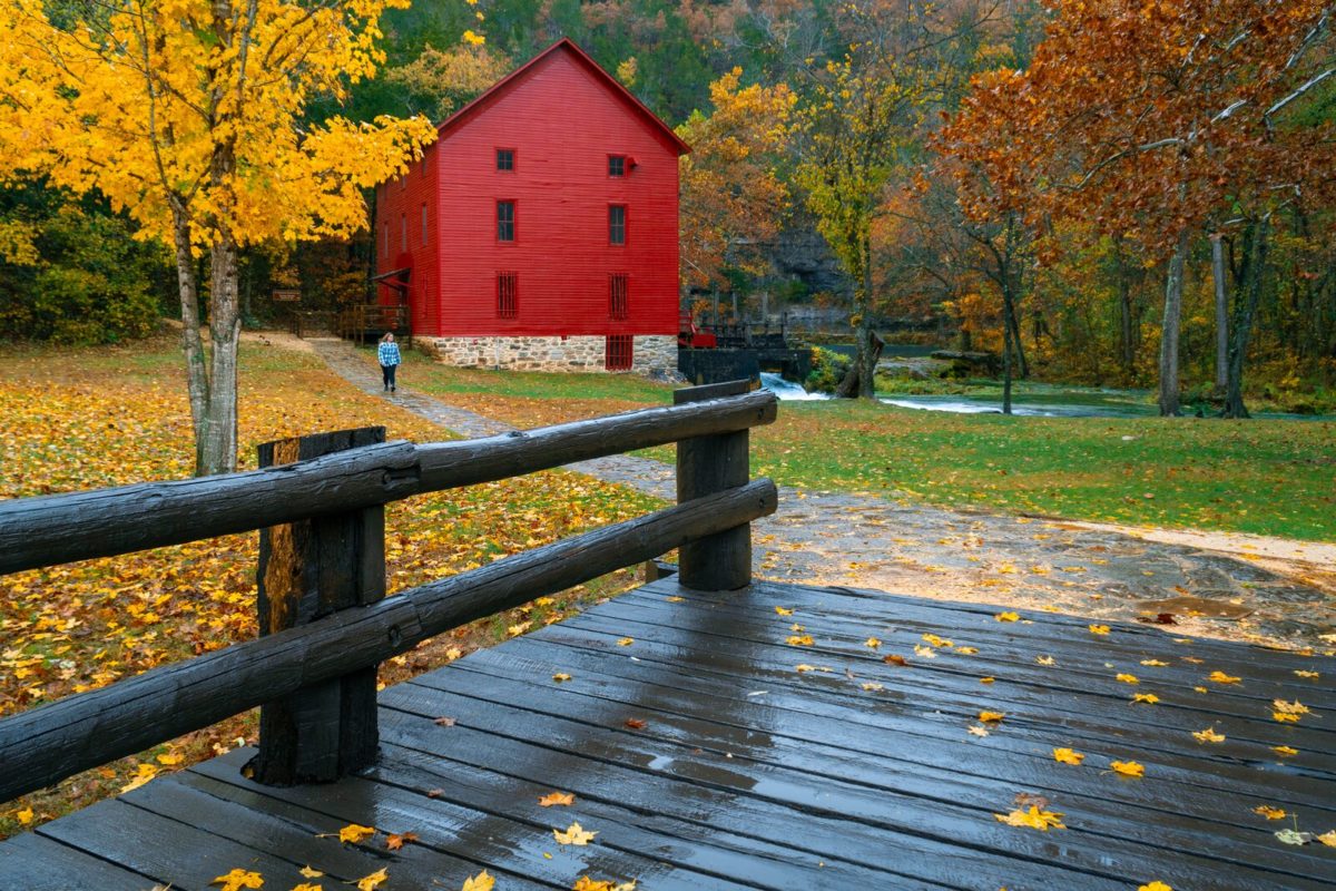 The Alley Spring Mill surrounded by colorful fall foliage.