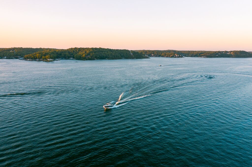 A boat makes it's way through the main channel of the Lake of the Ozarks at sunset.