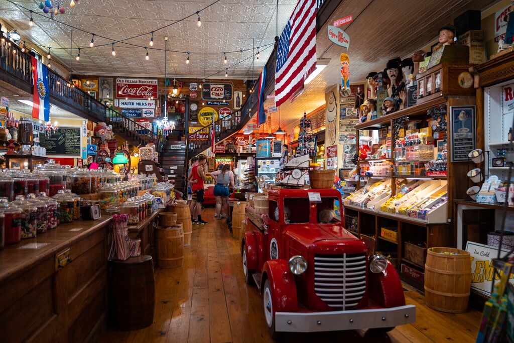 Vintage style store with glass candy jars, vintage tin signs and bright colored decor.