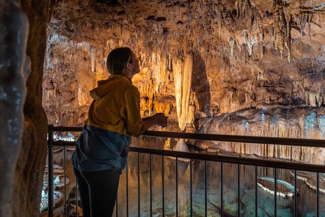 A young woman admires the formations in Onondaga Cave.